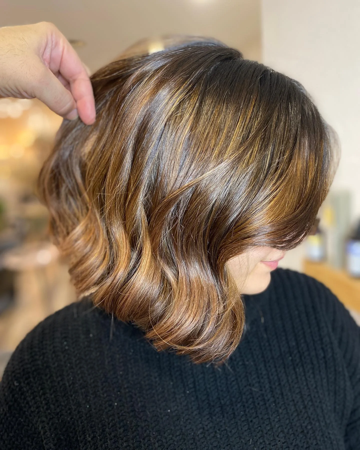 Short wavy brunette bob with broad golden-caramel ribbons