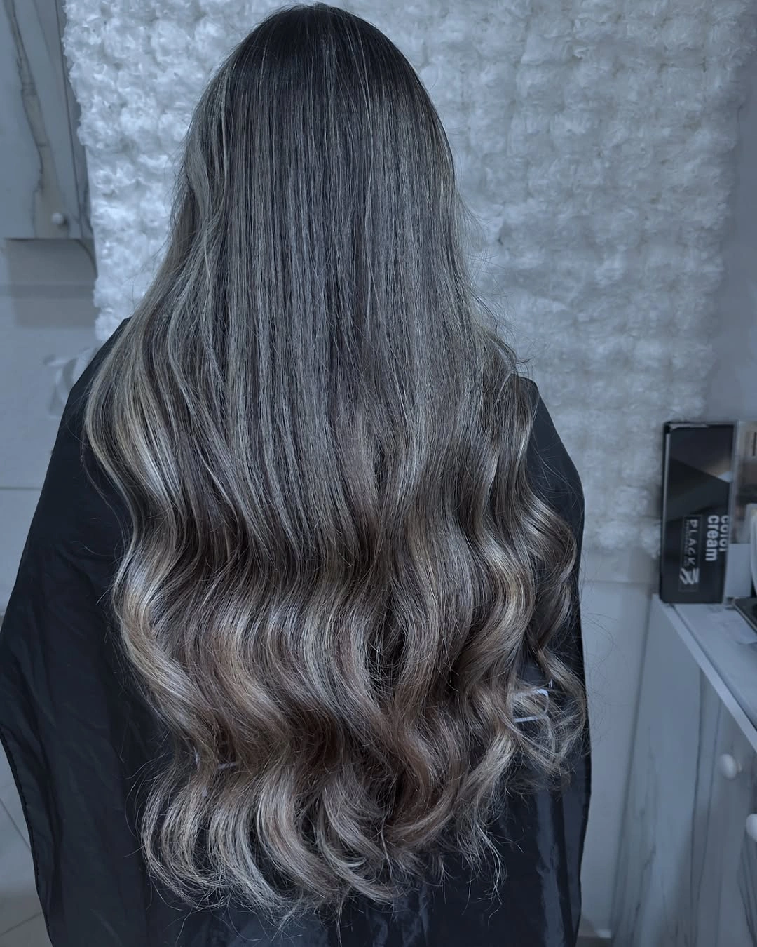 Long cool brunette waves with silvery-looking lower ribbons