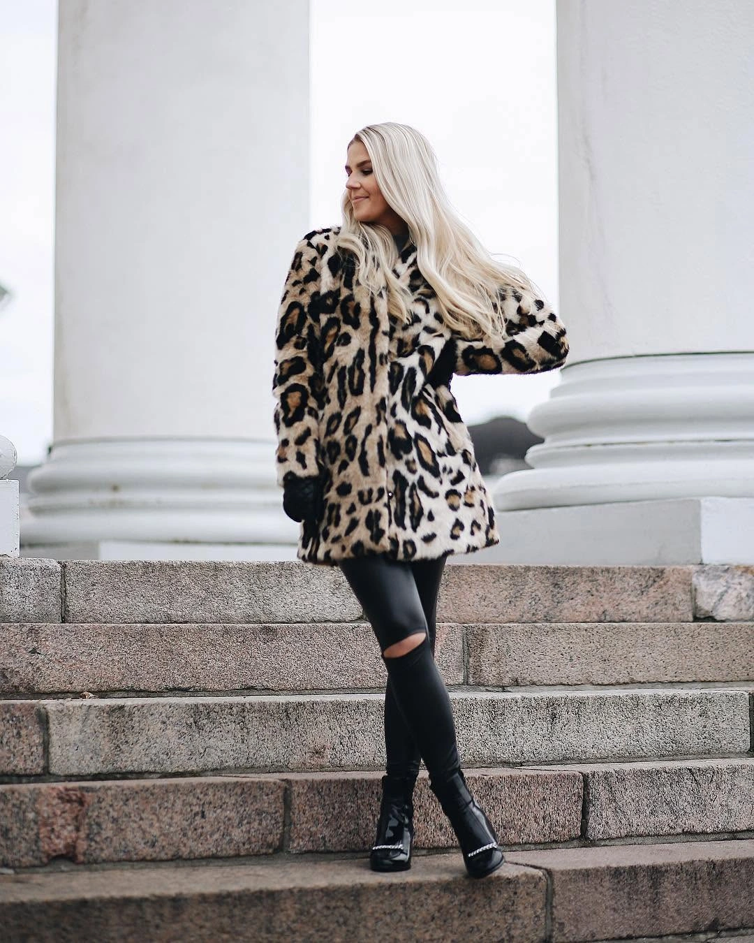 Leopard print coat with black bottoms and tall glossy black boots