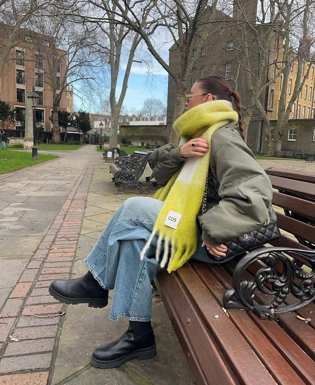 Olive jacket with lime scarf, wide blue jeans, and black ankle boots