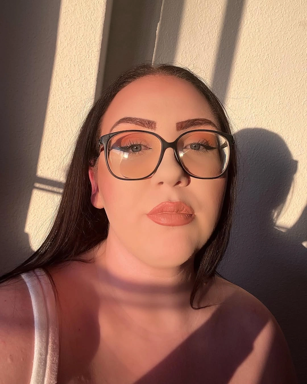 Long straight dark hair with center part and large glasses
