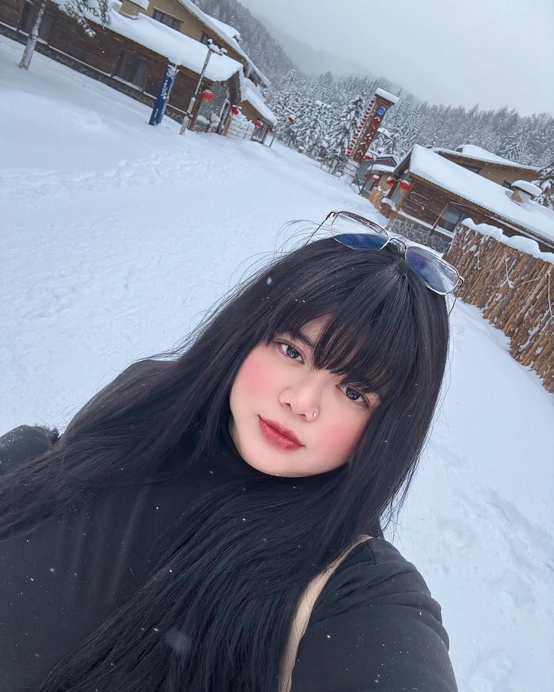 Long black hair with full bangs in snowy outdoor setting