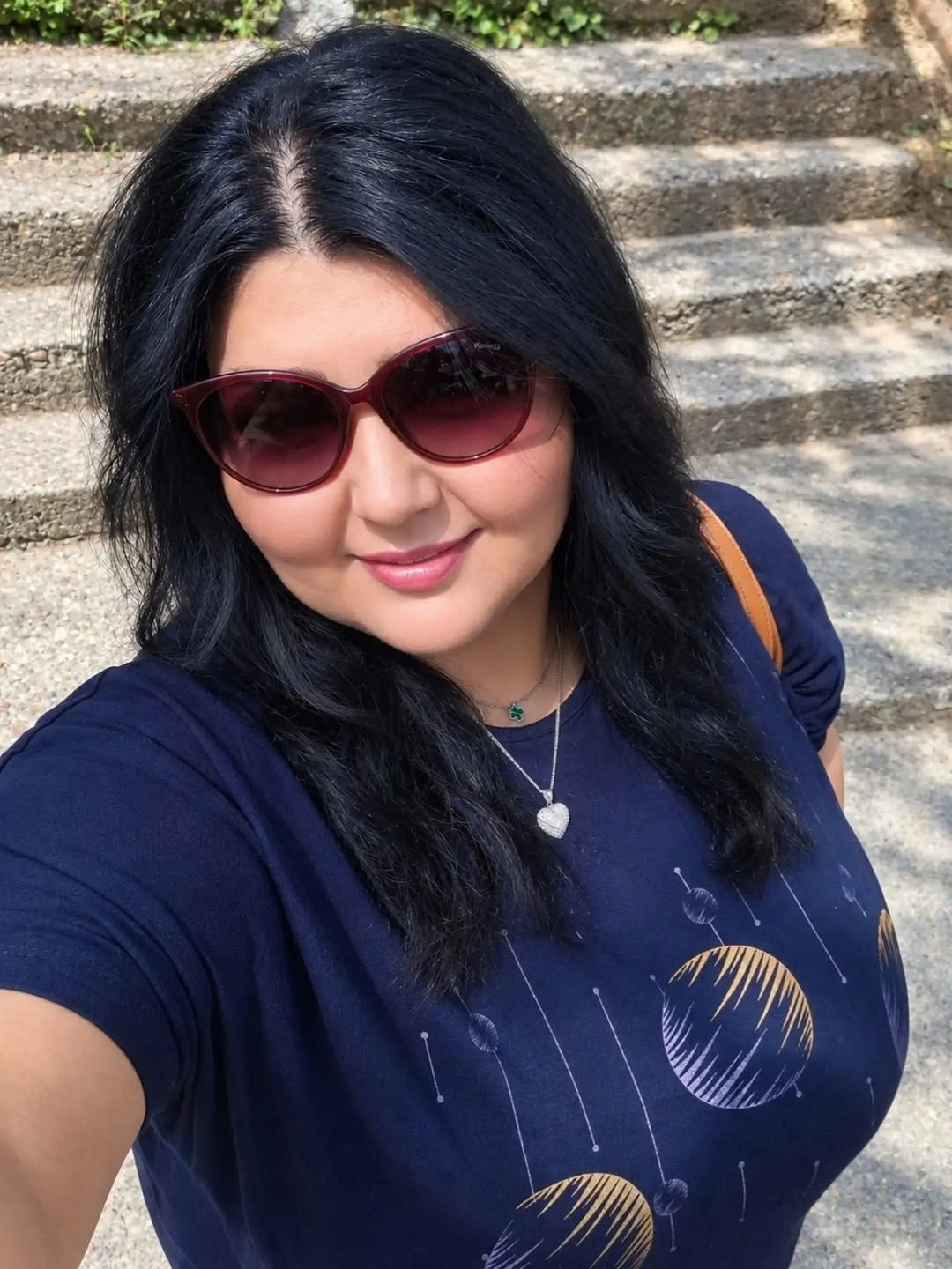 Dark medium hair with center part and sunglasses outdoors
