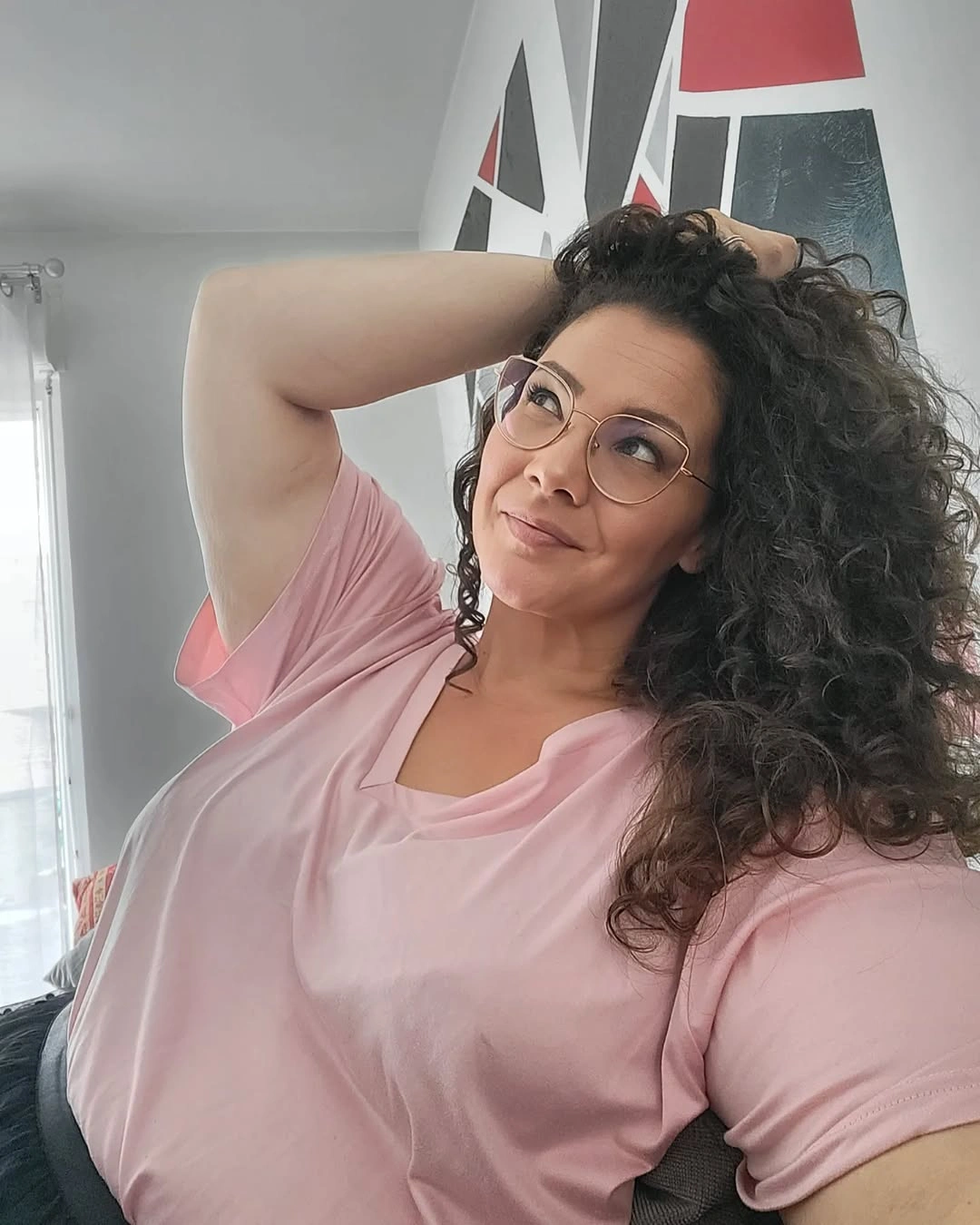 Long dark curls swept to one side with glasses