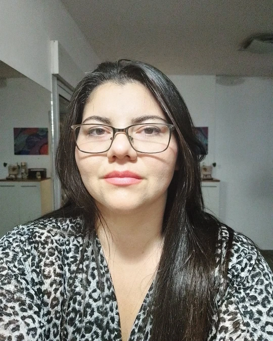 Long straight dark hair with glasses and leopard-print top