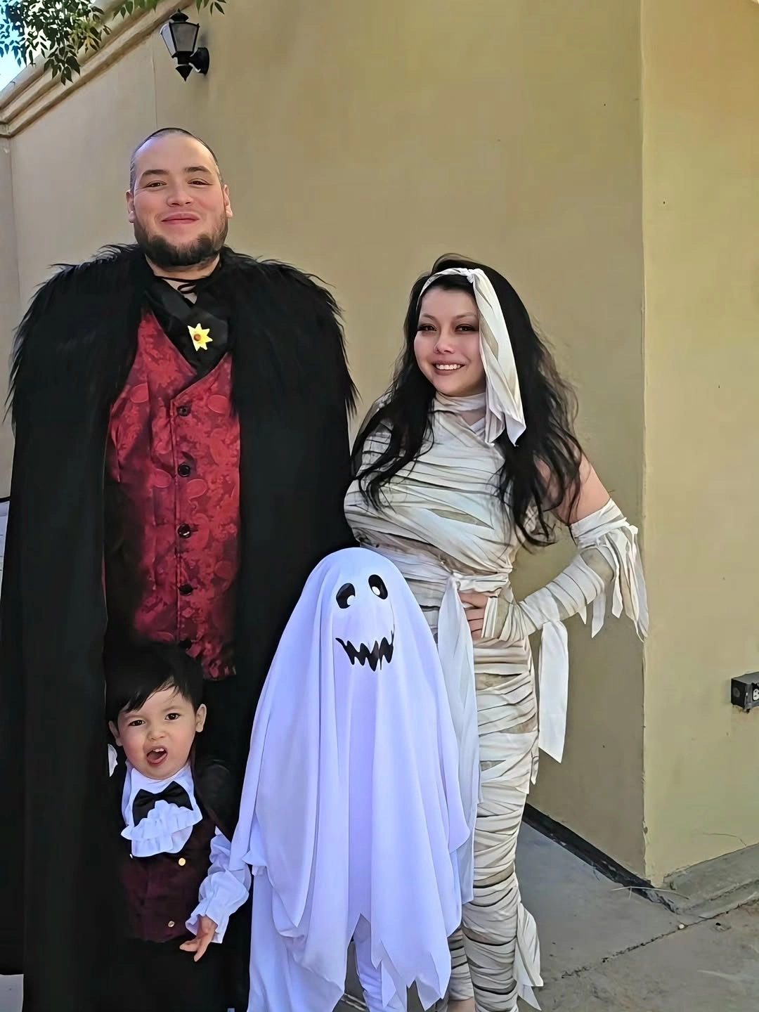 Vampire family Halloween costumes with small ghost and red waistcoat