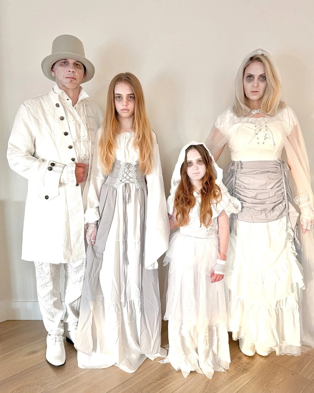 Pale family Halloween outfits with flowing ghost-inspired layers