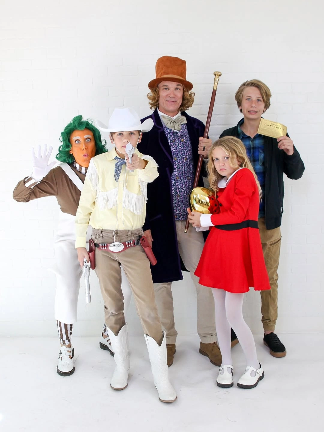 Family Halloween costumes with green-haired character and western outfits