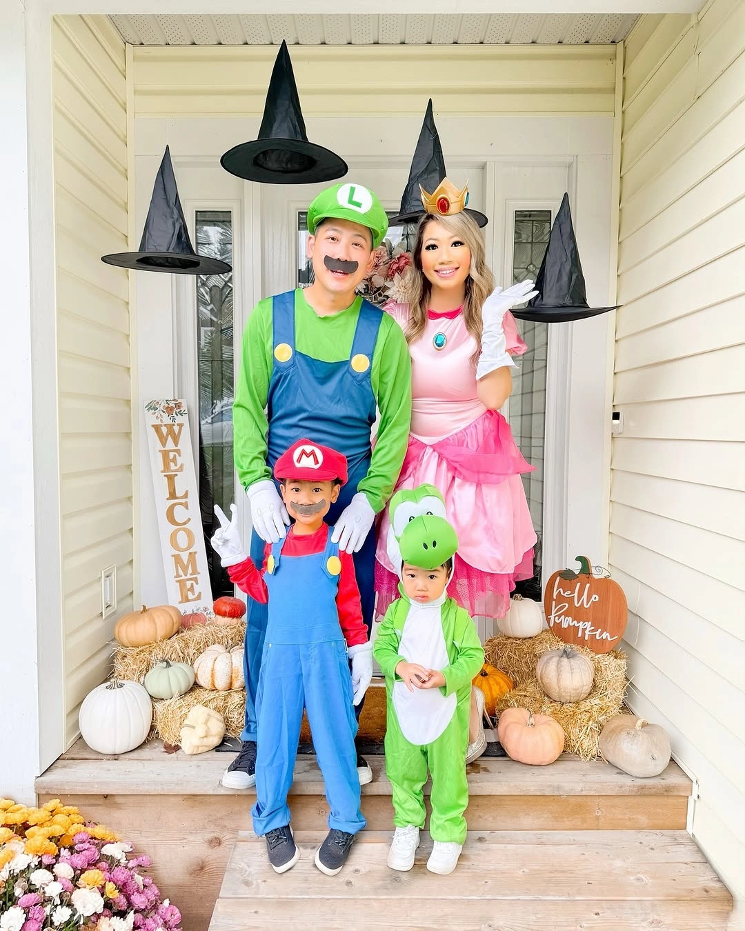 Game character family Halloween costumes with witch hats and pumpkins