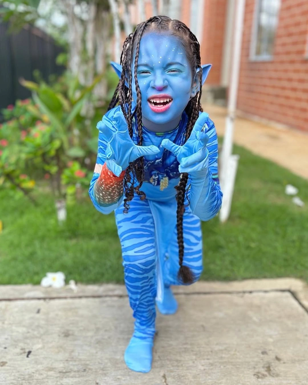 Blue full-body character Halloween costume with braids and red accents