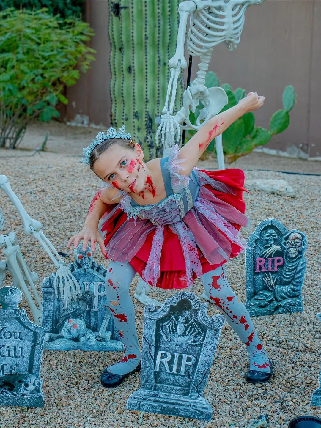 Spooky pink and blue ragged doll Halloween costume with tombstones