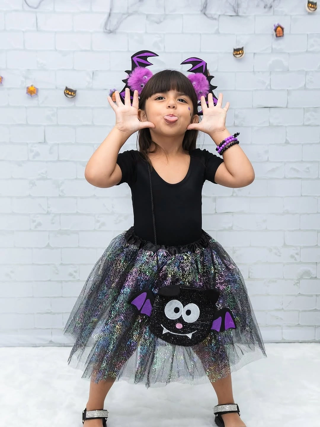 Black bat costume with iridescent tulle skirt and purple headwear