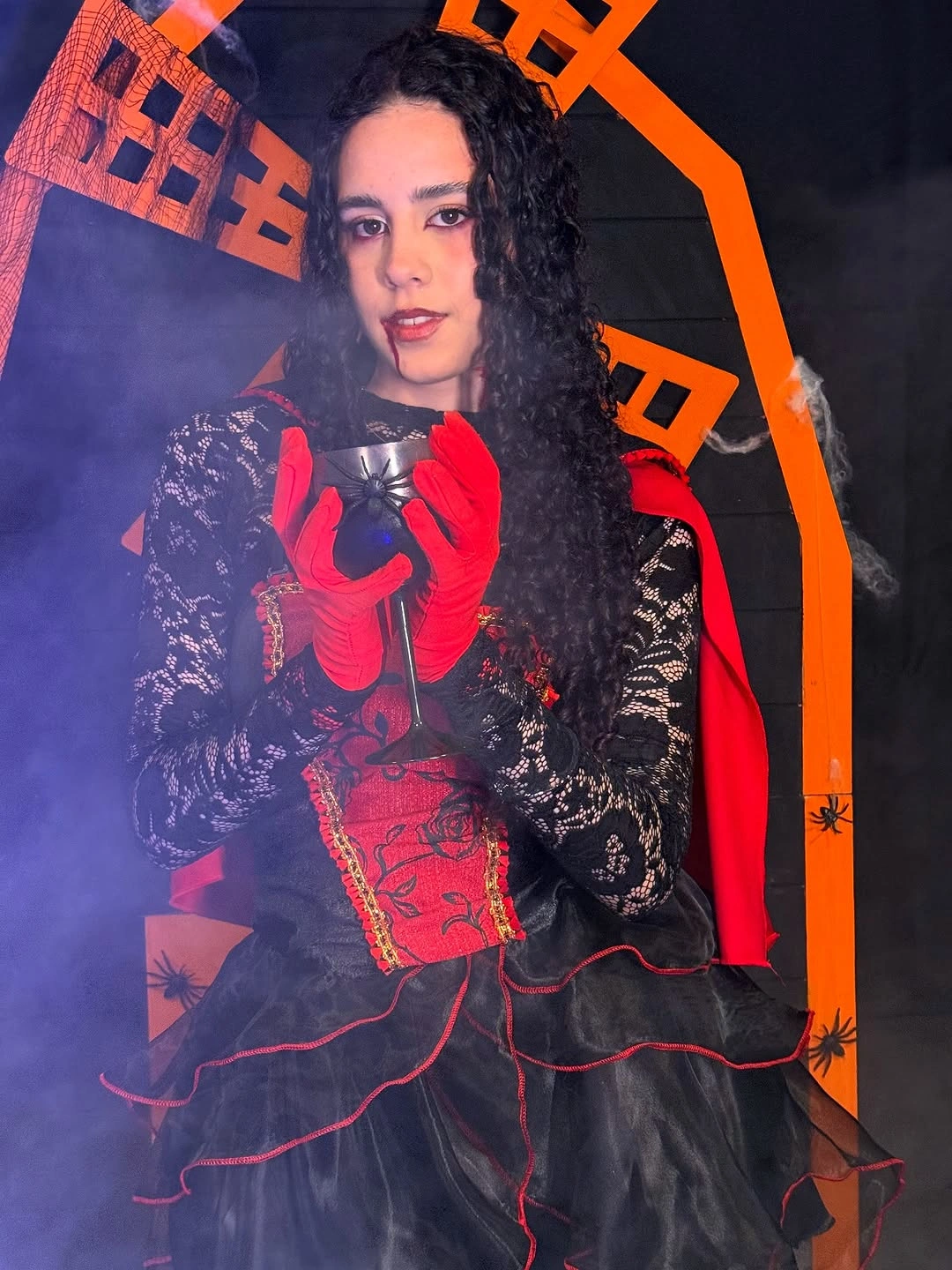 Layered black and red theatrical Halloween costume with red gloves