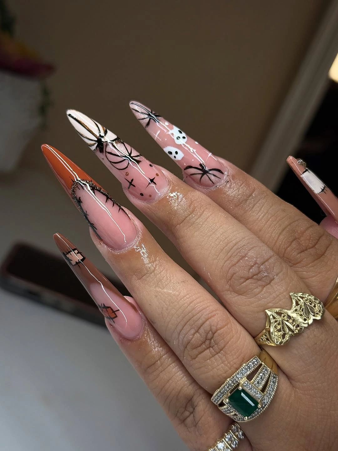 Long pink almond Halloween nails with webbing stitches ghost and orange