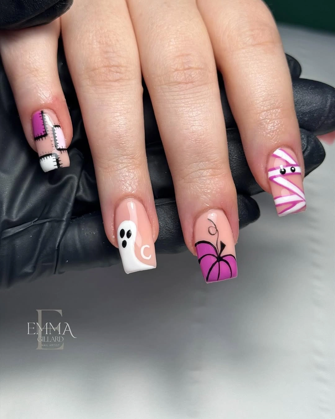 Short pink square nails with tiny white ghost and stitched accents