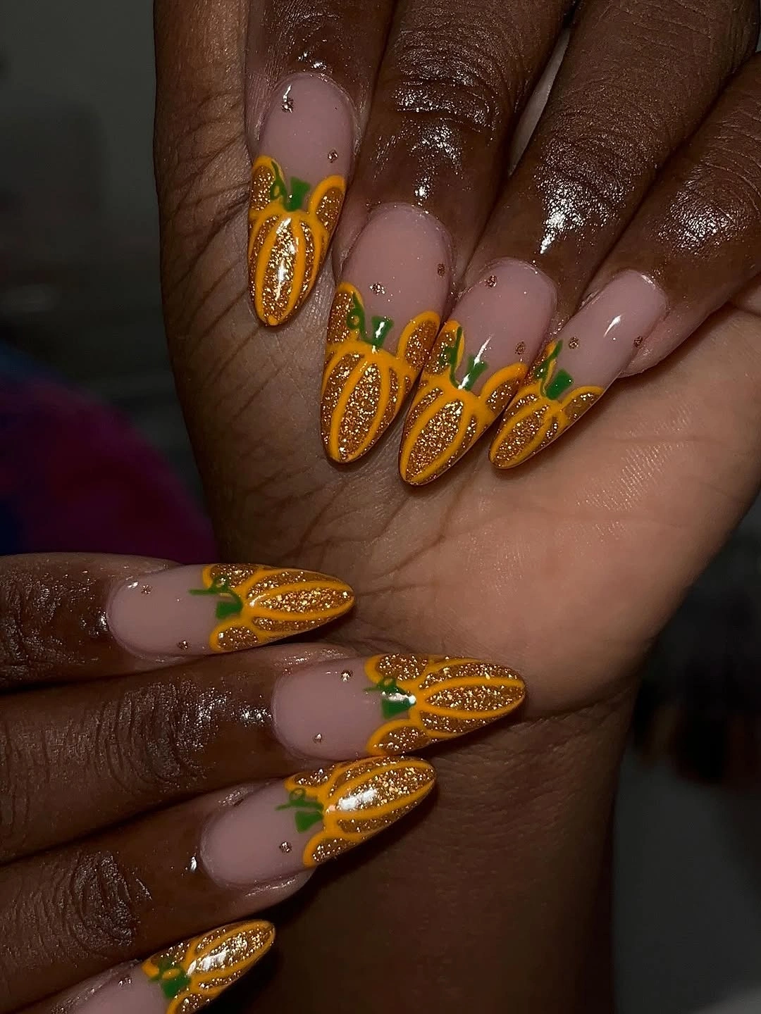 Medium nude almond nails with glittery raised orange pumpkins