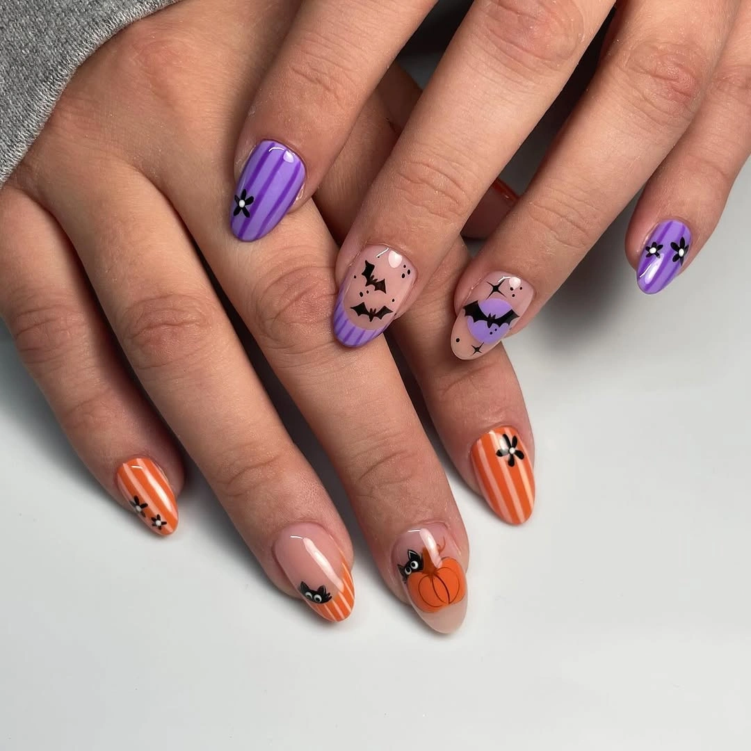 Medium almond lilac and pink Halloween nails with bats pumpkins