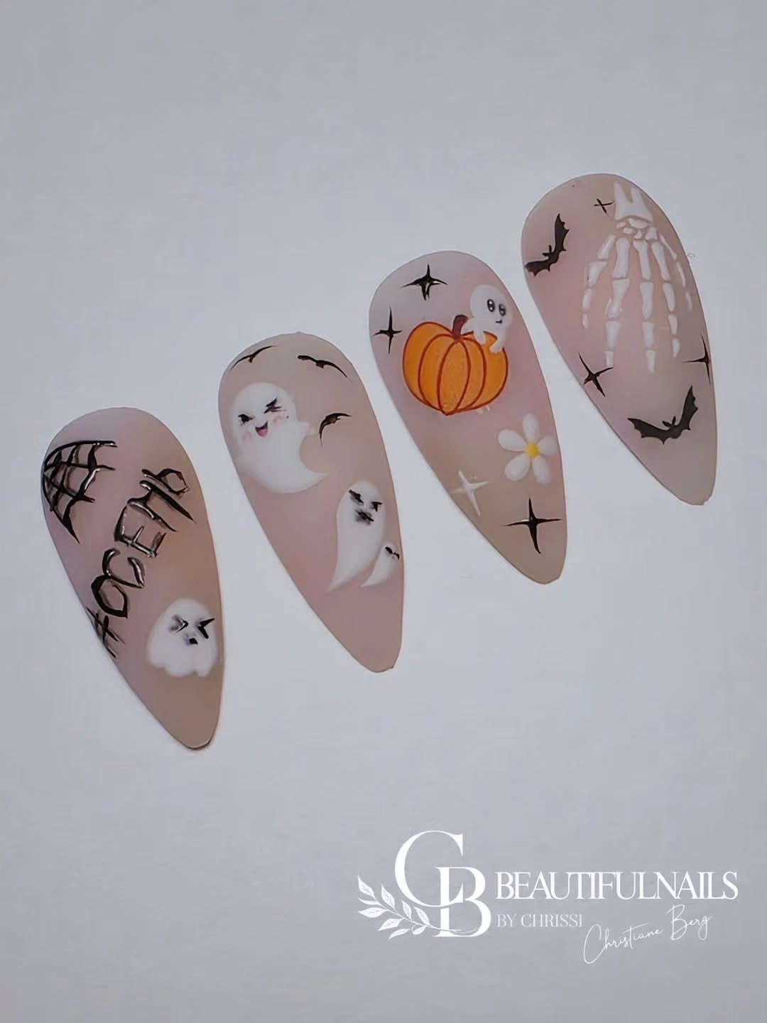 Nude almond nail sample tips with bats ghosts web and pumpkin