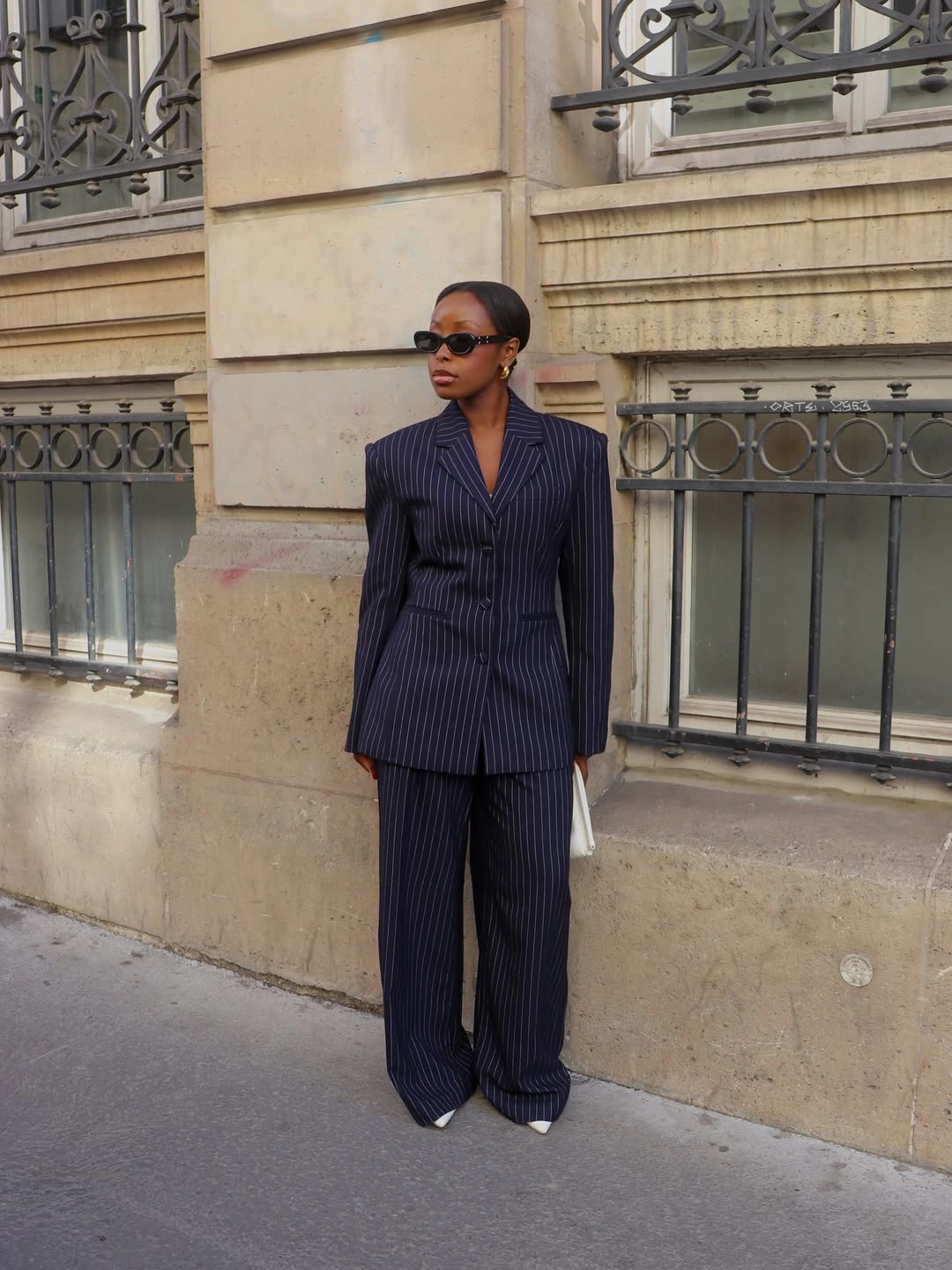 Navy pinstripe suit with wide trousers and white pointed shoes