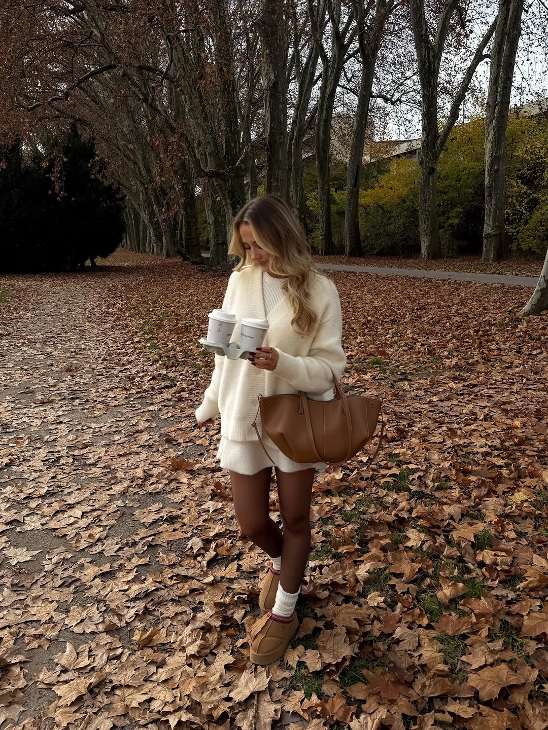 Cream short layers with brown tights and tan tote