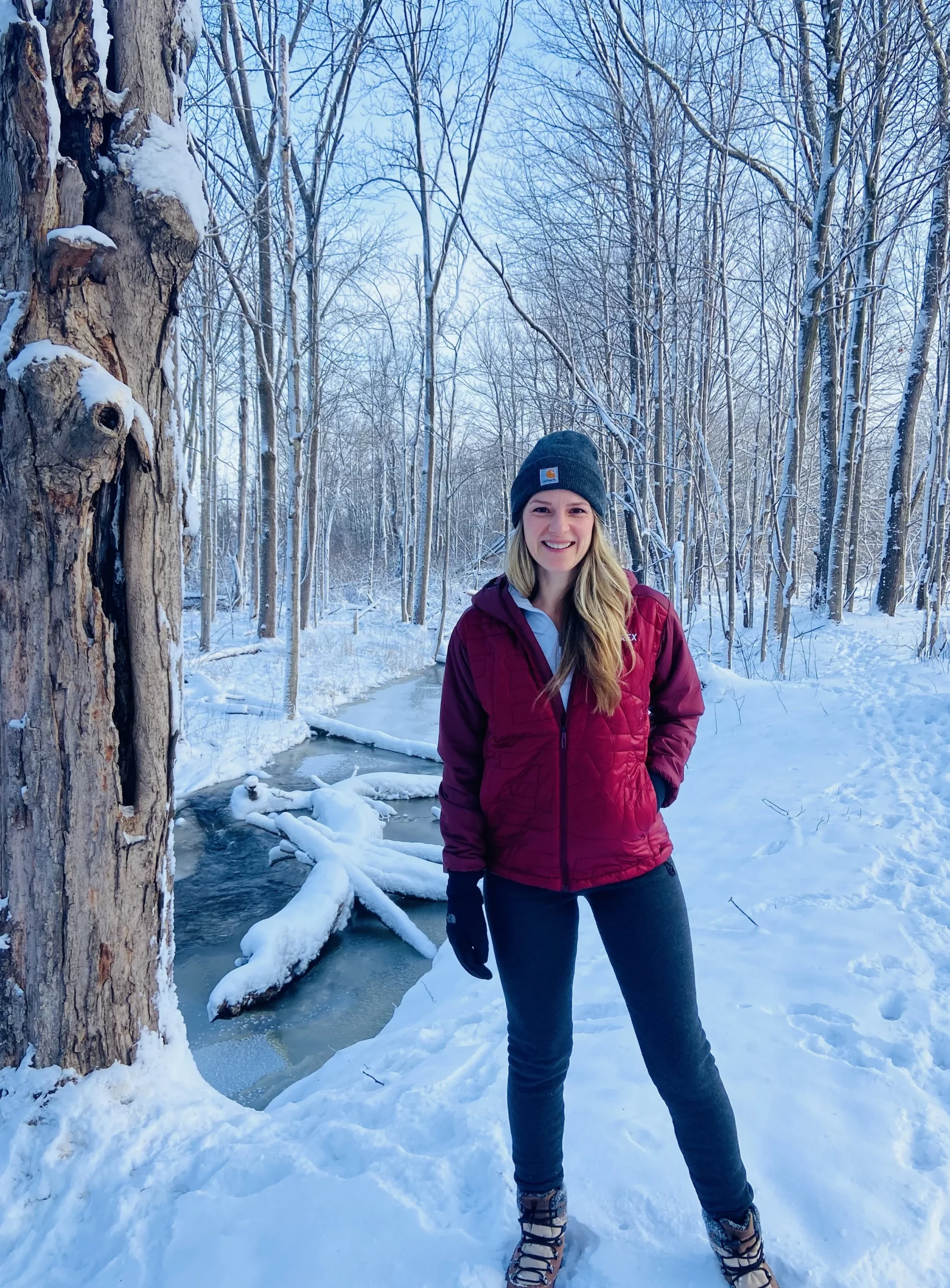 Maroon Puffer and Grey Leggings in Snowy Forest — Winter Hiking Outfits