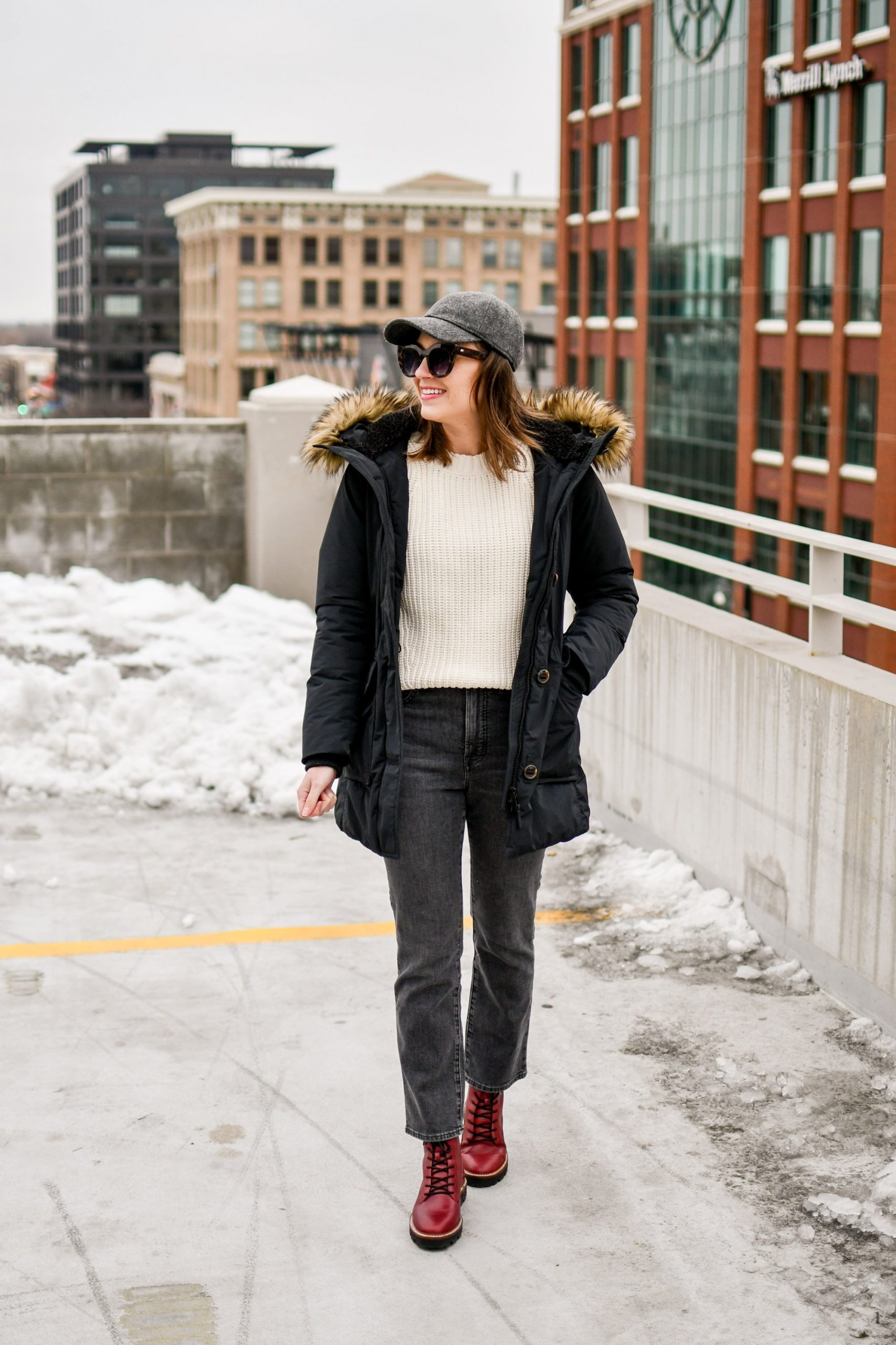 Red Lace-Up Boots with Grey Jeans and Black Parka — Winter Boots Outfits