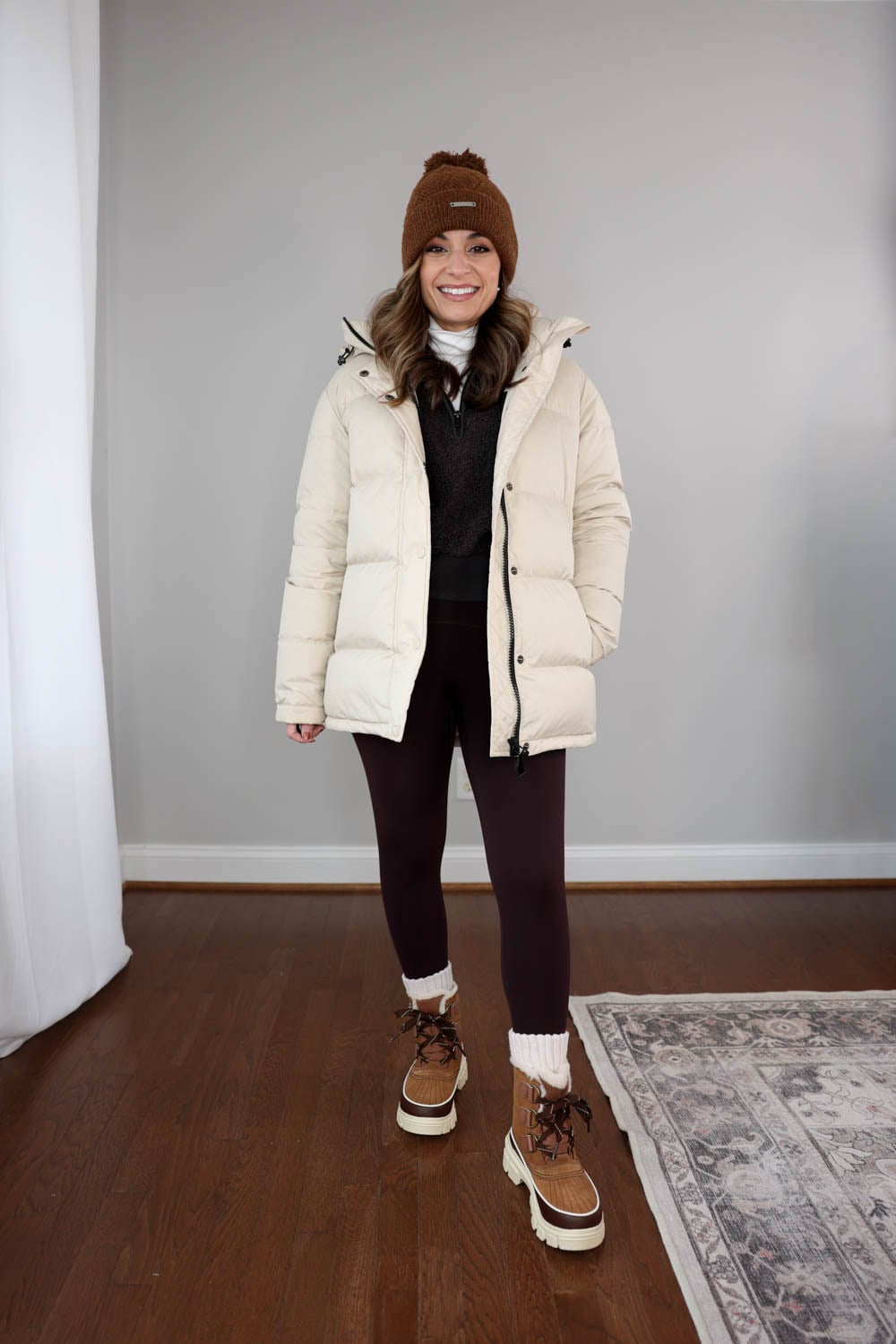 Brown Lace-Up Boots with Cream Puffer Jacket and Dark Leggings — Winter Boots Outfits