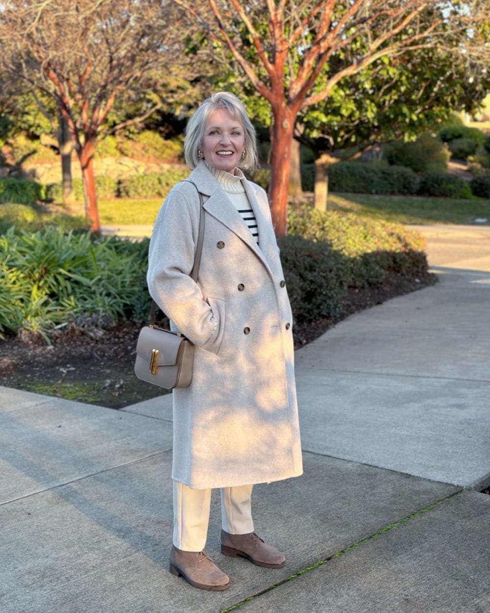 Chic Cream Wool Coat Over Striped Turtleneck and Trousers — Winter Outfits for Older Women