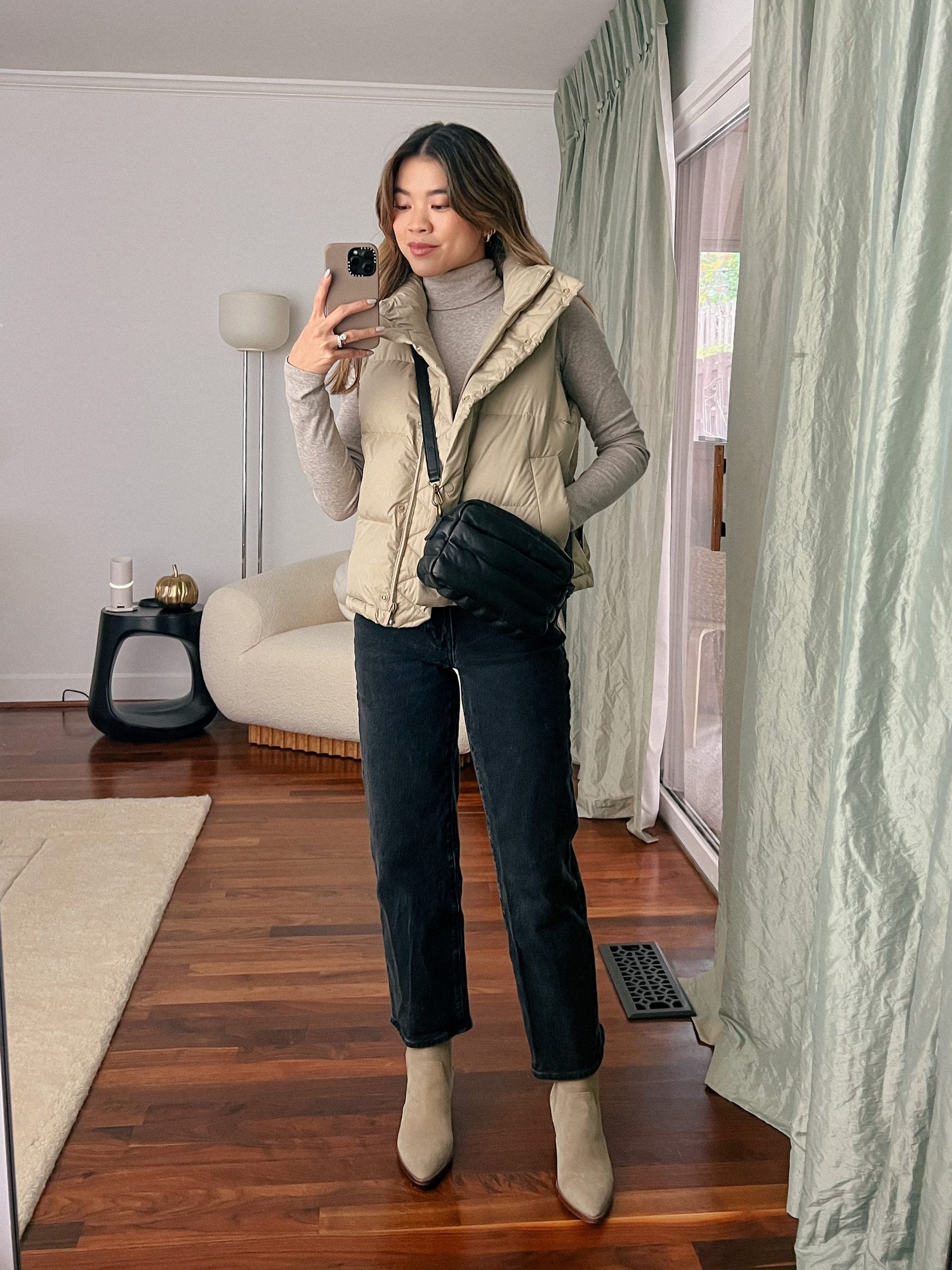 Casual Winter Beige Puffer Vest with Grey Turtleneck and Black Jeans Casual Winter Beige Puffer Vest with Grey Turtleneck and Black Jeans — Puffer Vest Outfits