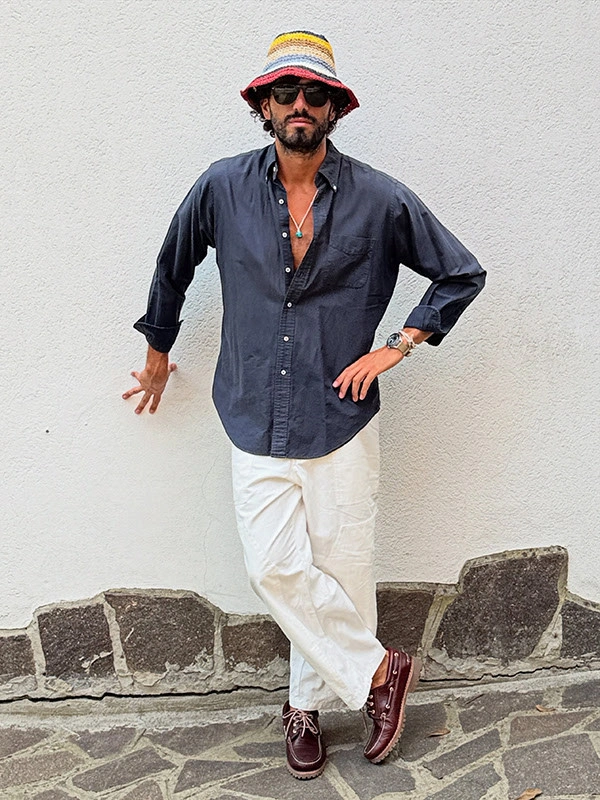 Navy open shirt white drawstring trousers striped bucket hat and burgundy shoes