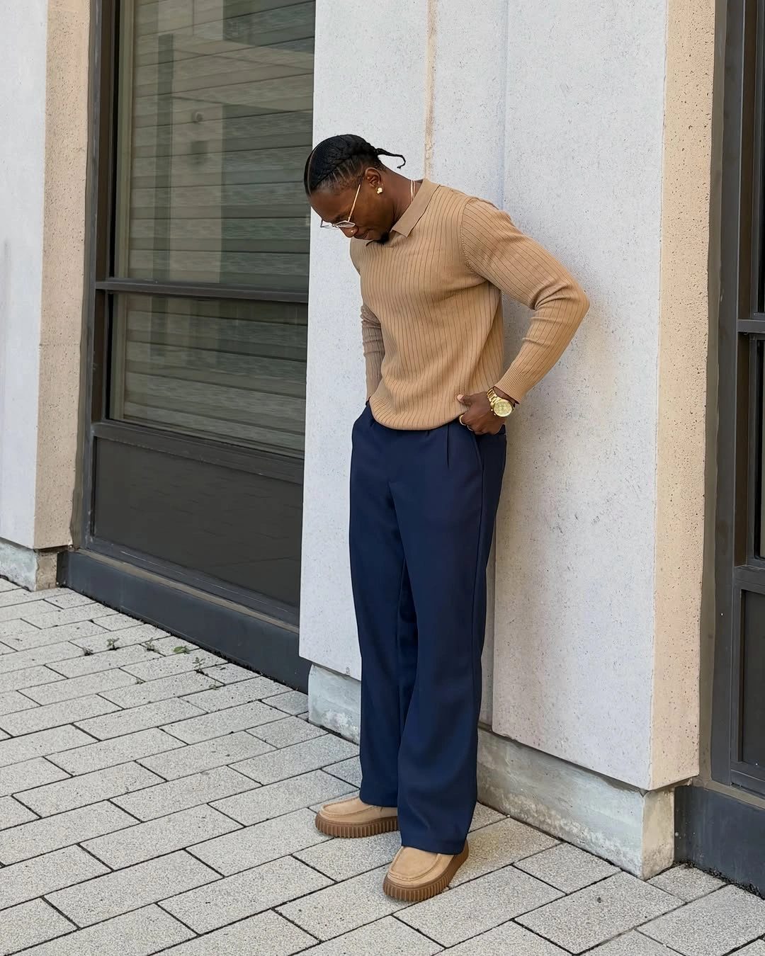 Camel ribbed sweater with navy wide trousers and tan shoes