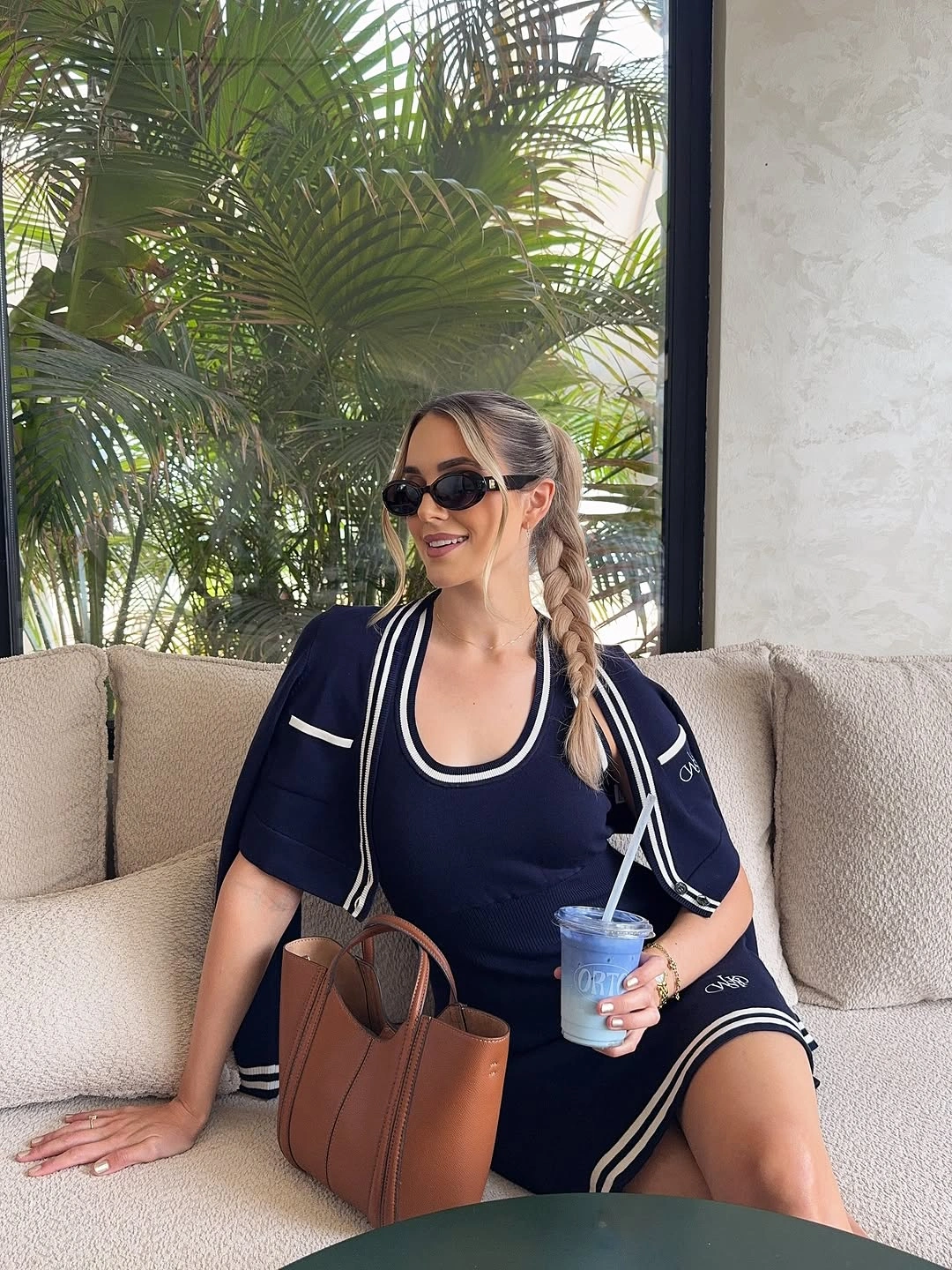 Navy short sleeve athletic dress white piping sunglasses tote and padel gear