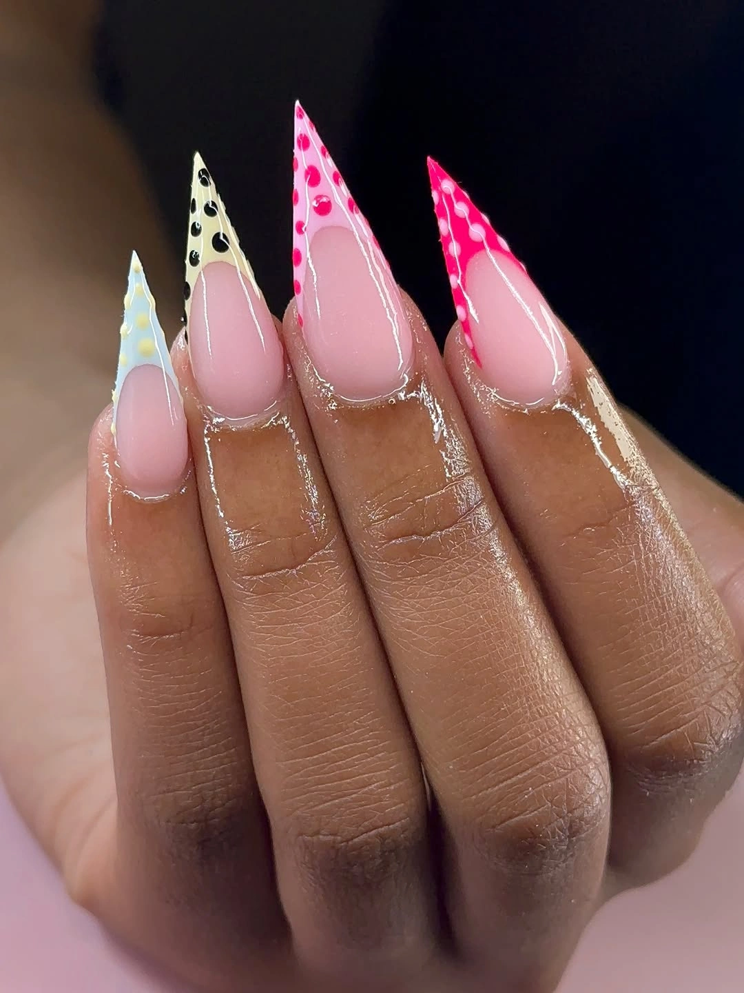 Long pointed nude pink nails with bright dotted tip accents