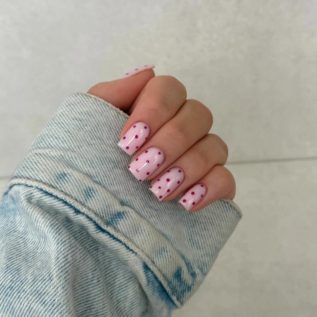Short pale pink square nails with tiny black micro dots