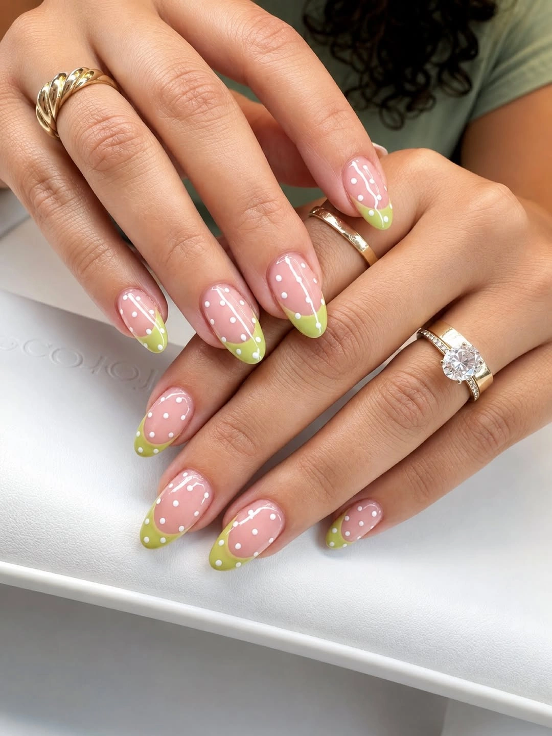 Nude almond nails with lime French tips and white polka dots