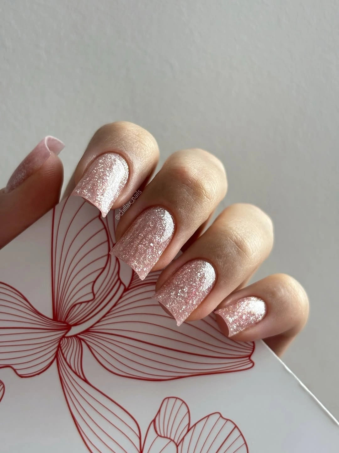 Rose pink glitter nails on short-to-medium square tips