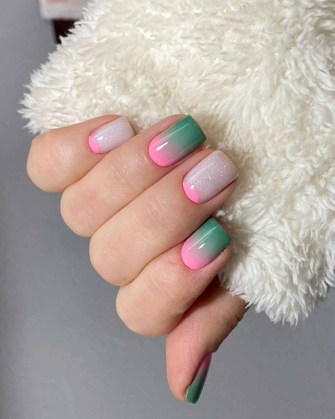Pink shimmer nails with green and pink gradient accents