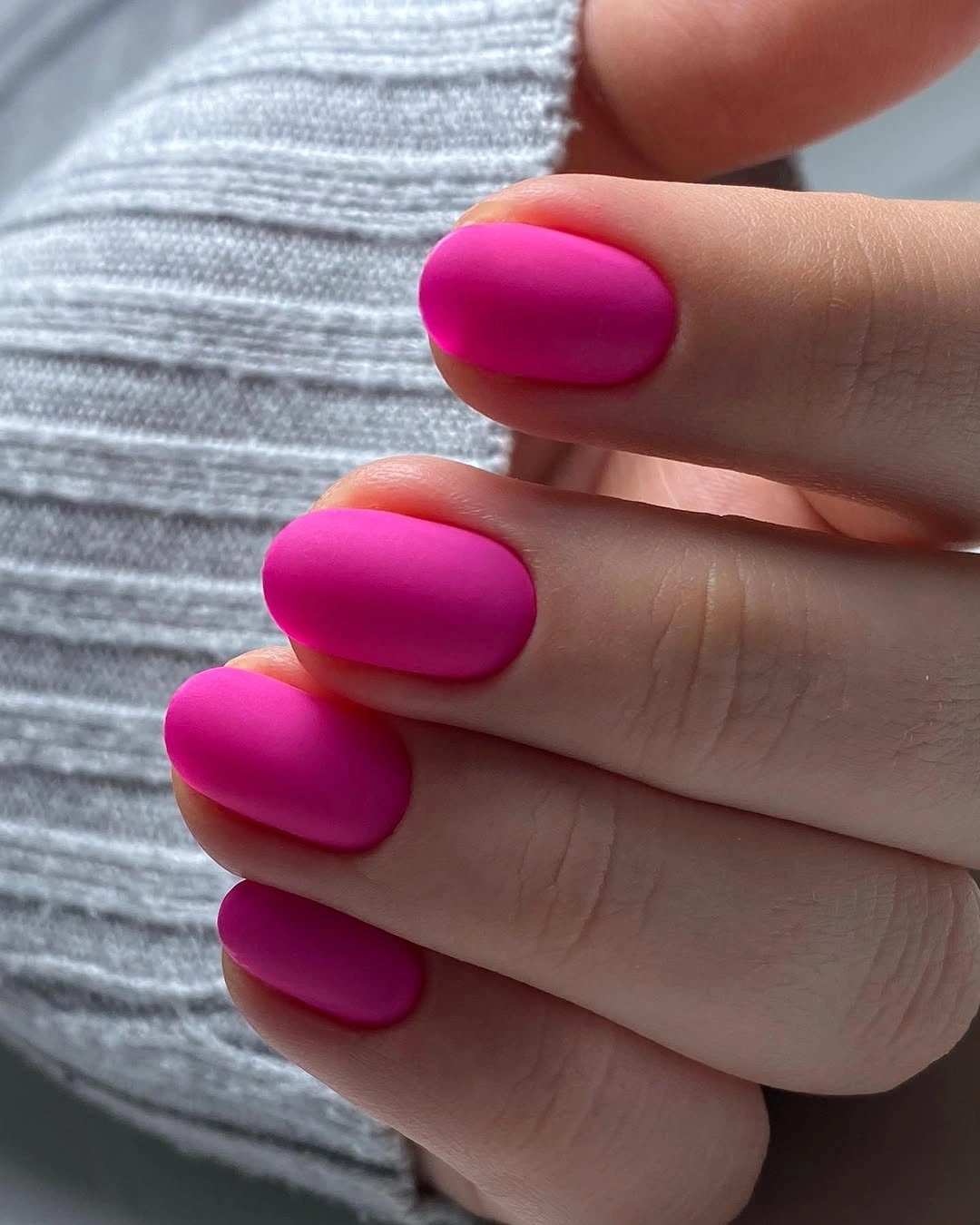 Compact oval nails with velvety-looking magenta polish