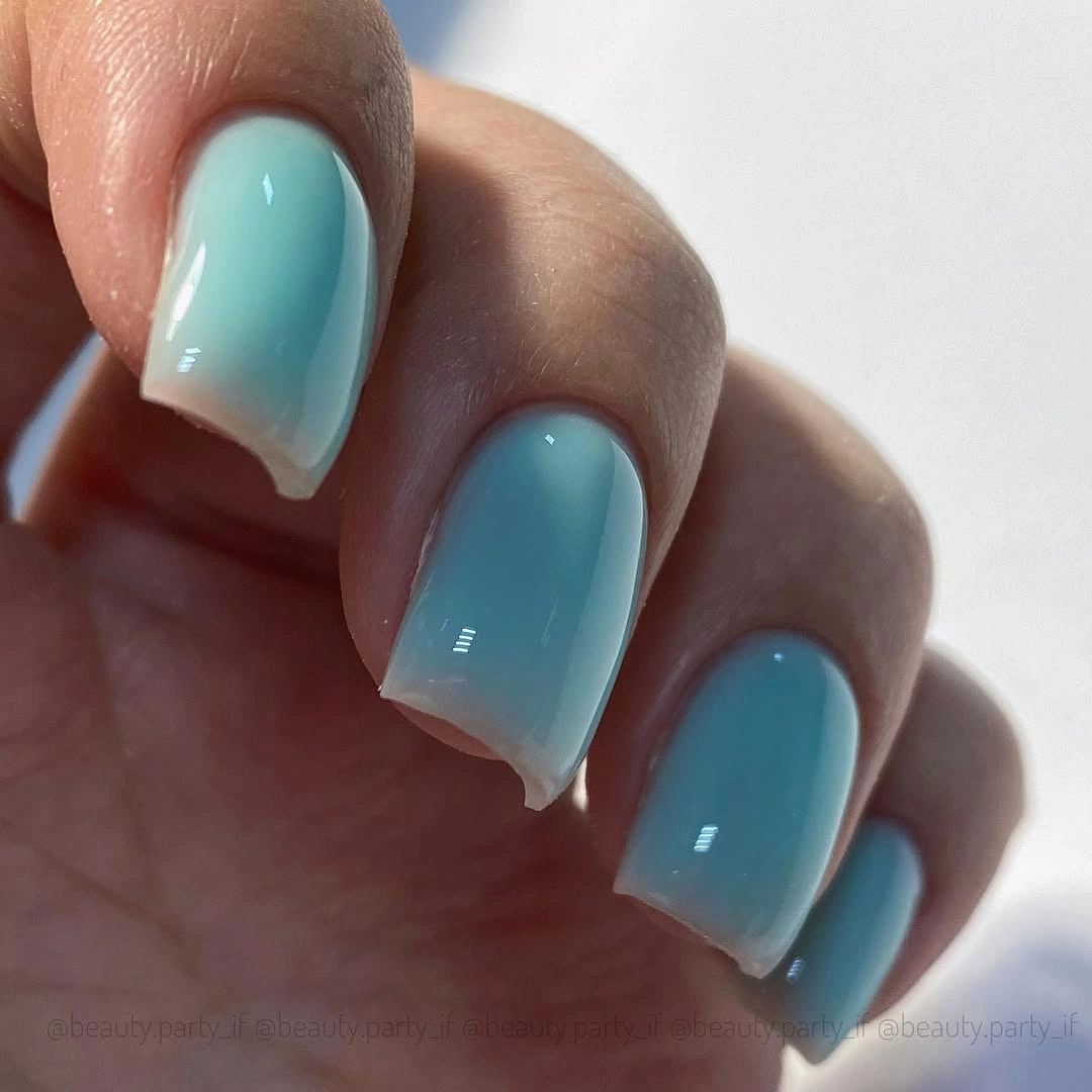 Glossy aqua soft square nails with milky translucent tips