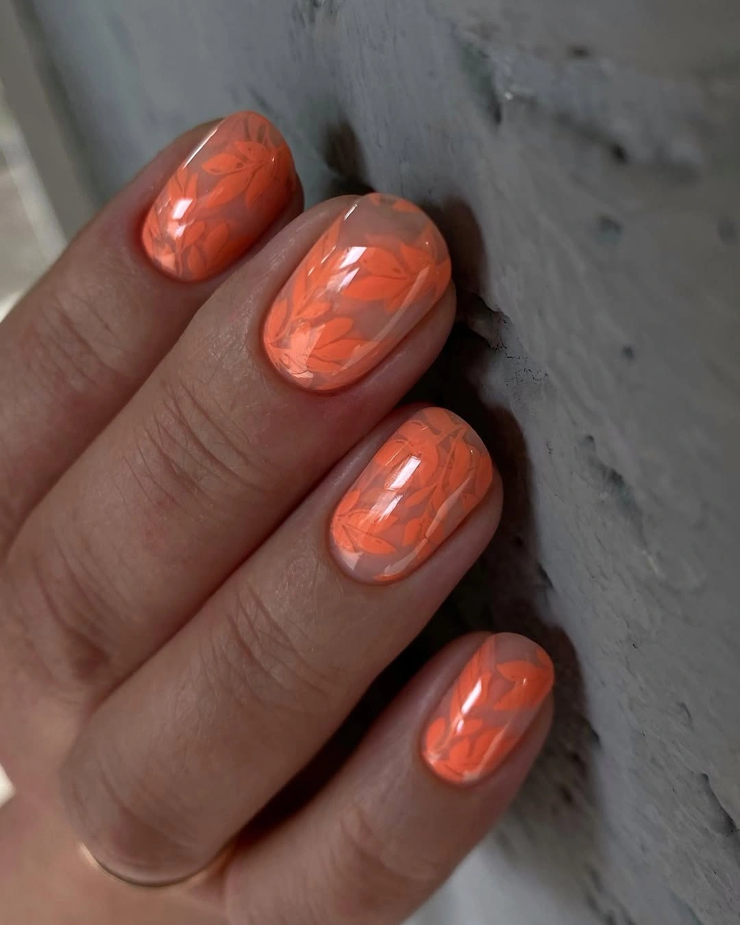 Coral short rounded square nails with glossy tonal leaf pattern