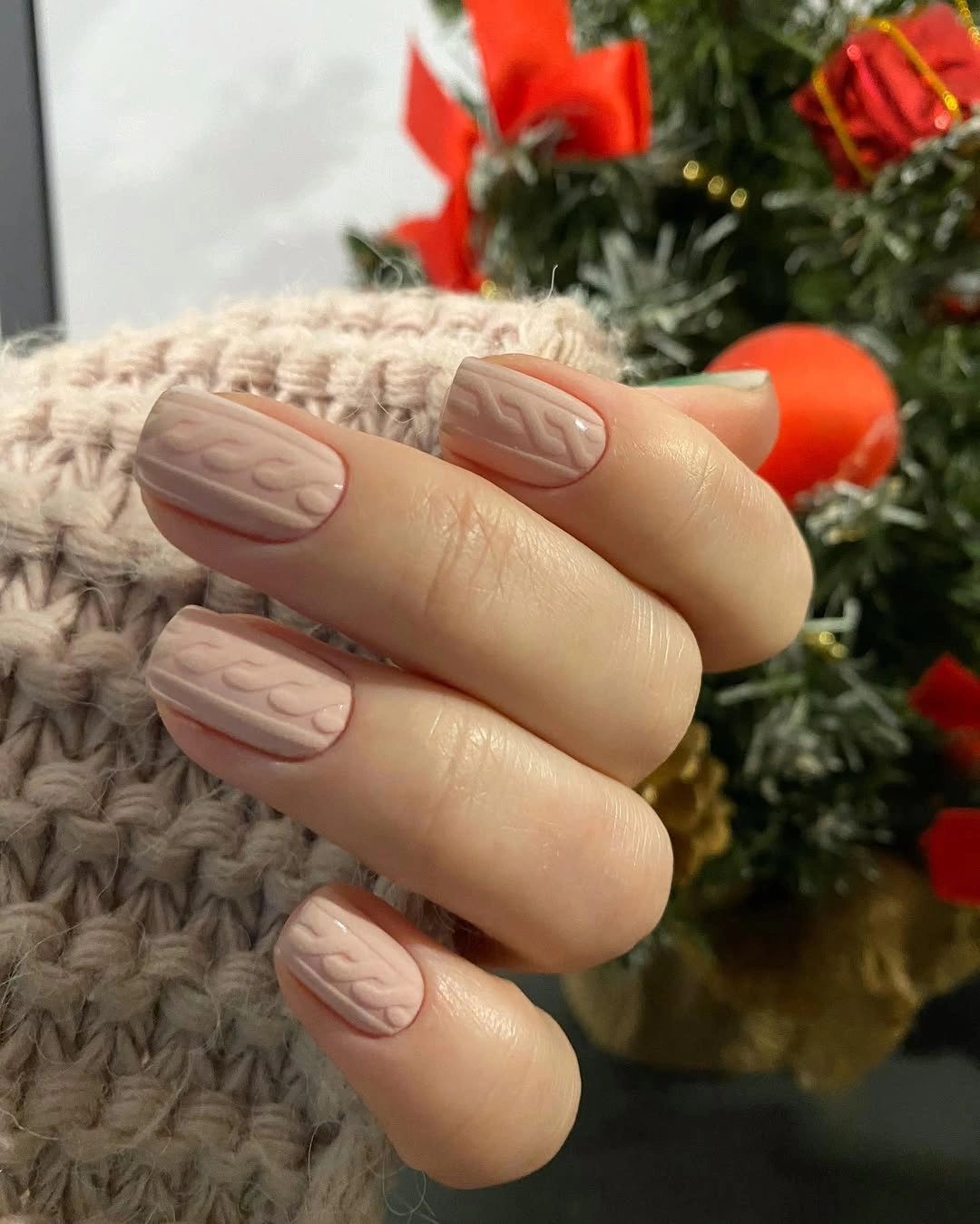 Beige short oval nails with raised cable-like texture
