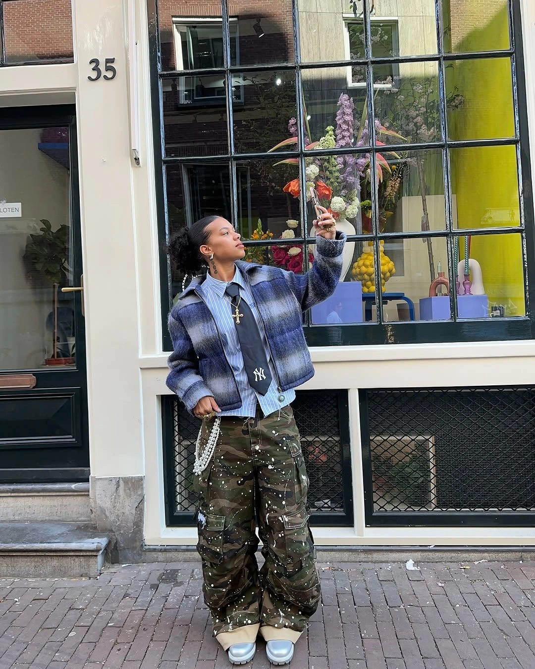 Blue purple plaid jacket with camouflage pants and navy cap
