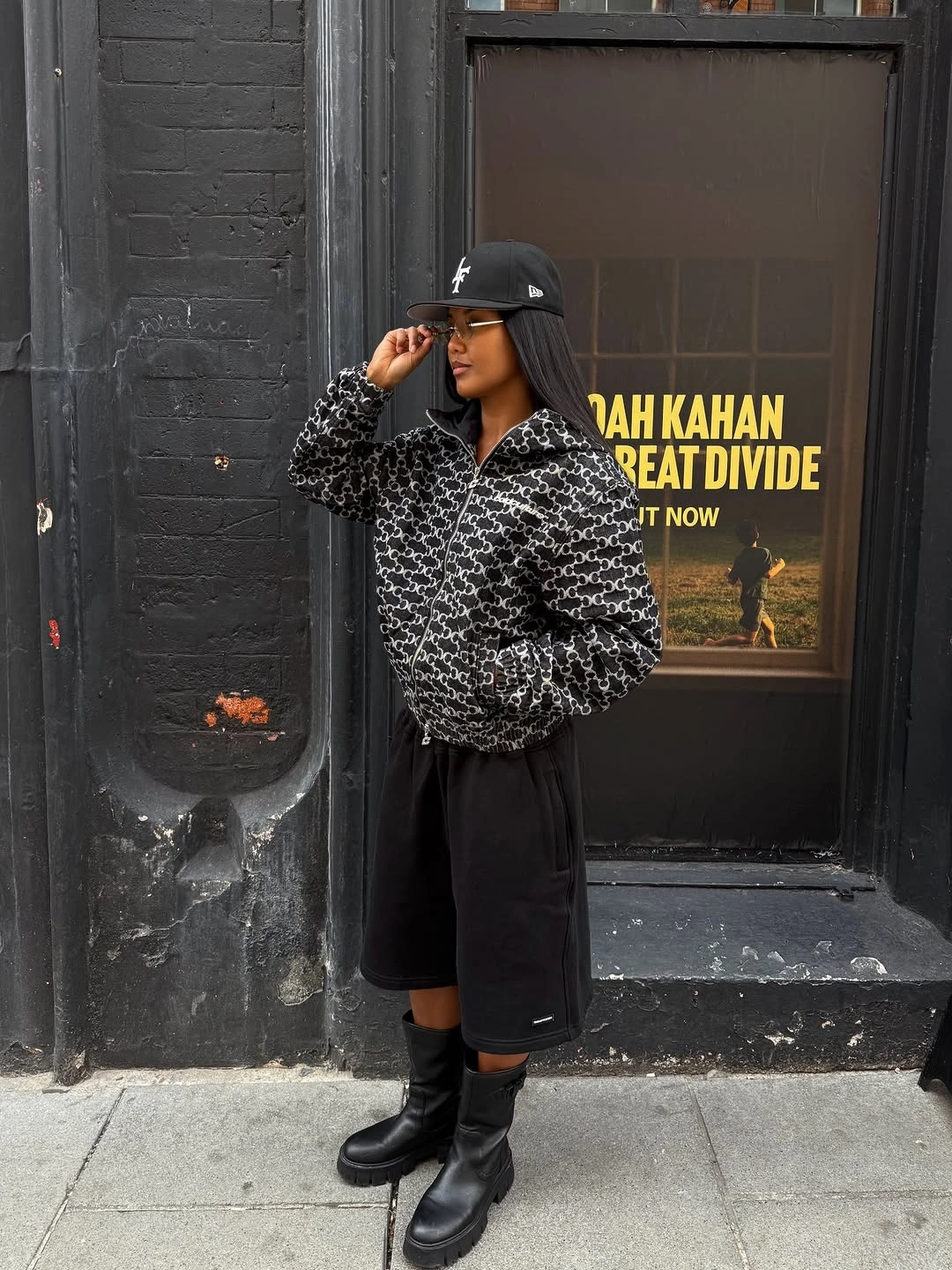 Leopard fuzzy jacket with long black skirt, cap, and boots