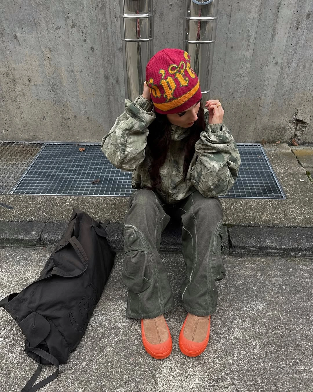 Camo jacket and loose cargo trousers with bright orange shoes