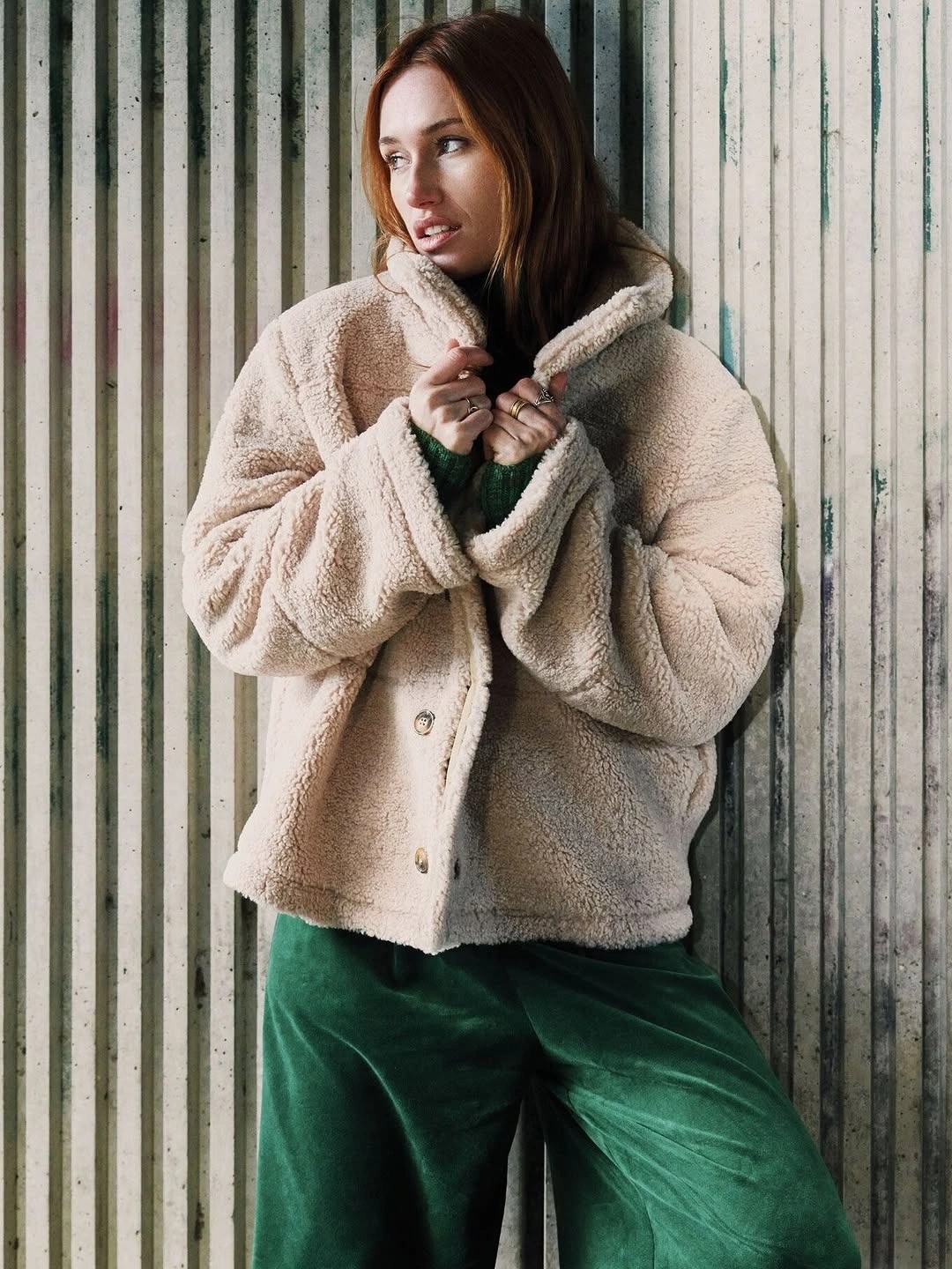 Cream textured jacket with green velvet trousers and black scarf
