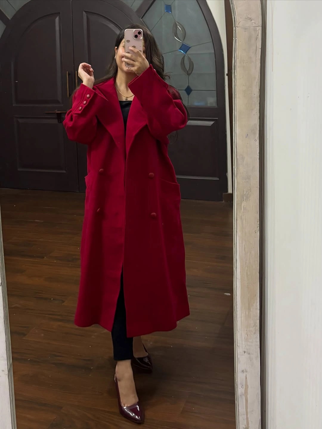 Red long belted coat with black outfit and burgundy heels