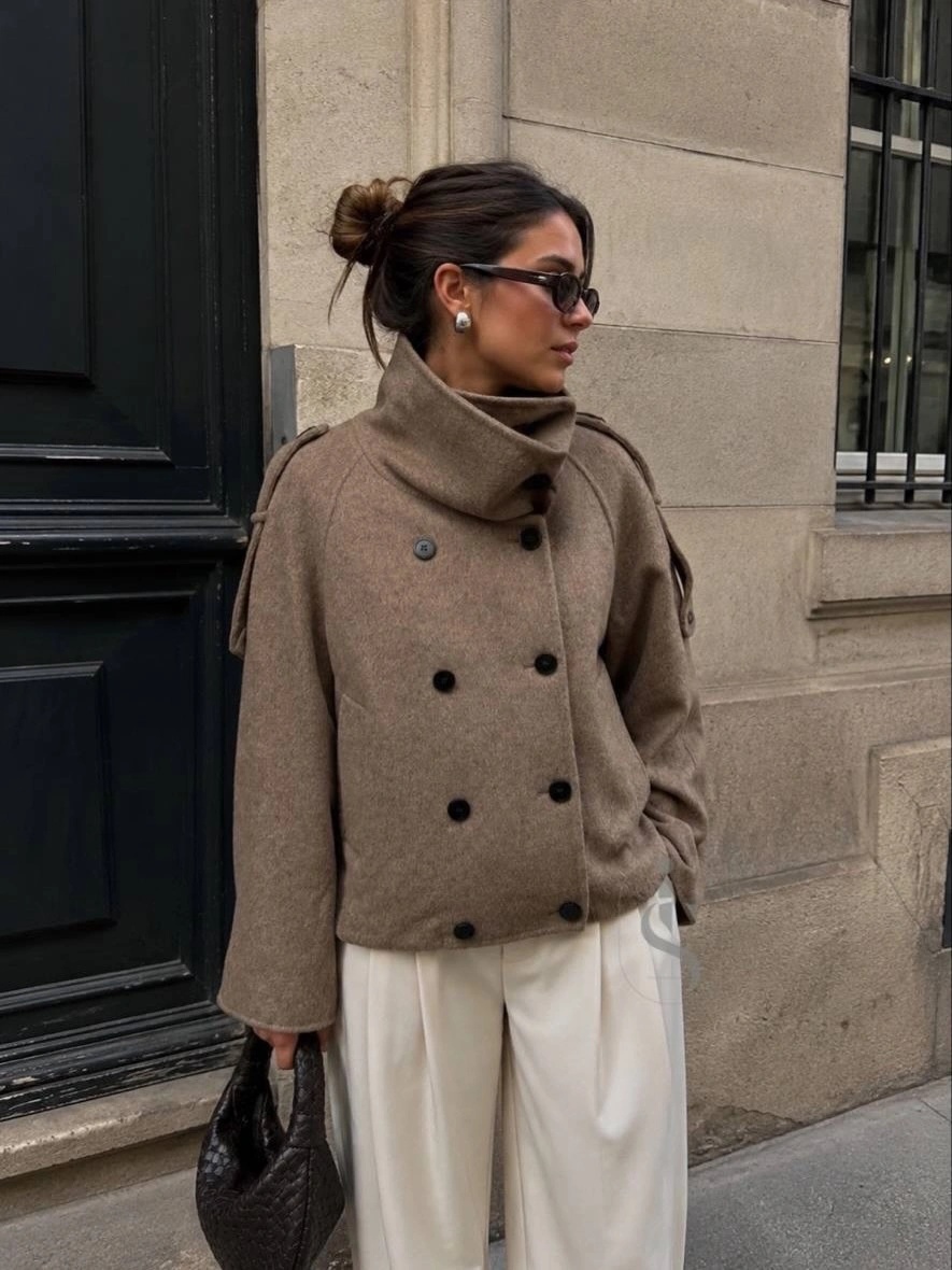 Taupe double-breasted short coat with white wide-leg trousers and bag