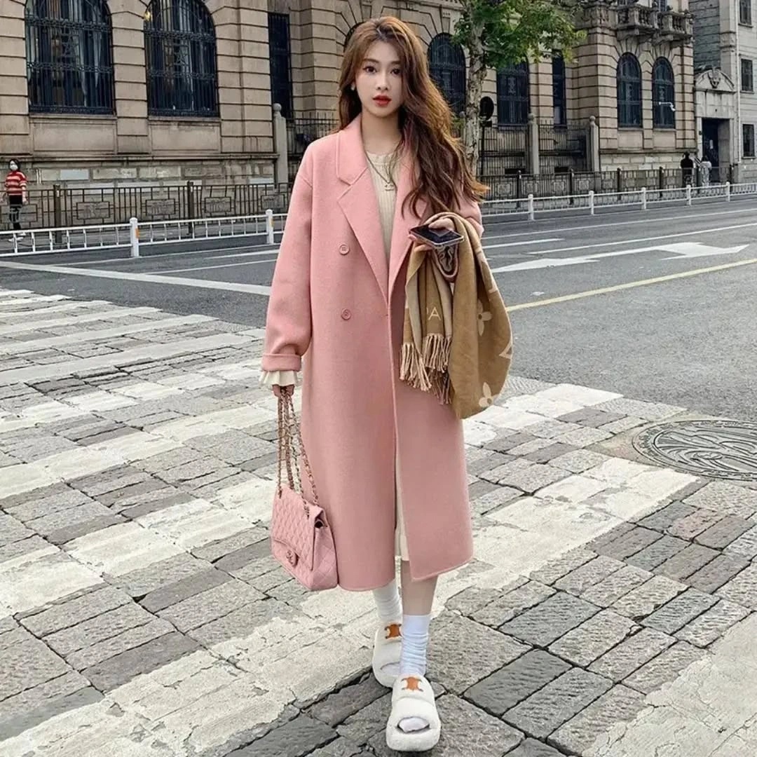 Long pink coat with beige scarf pink handbag and white sneakers