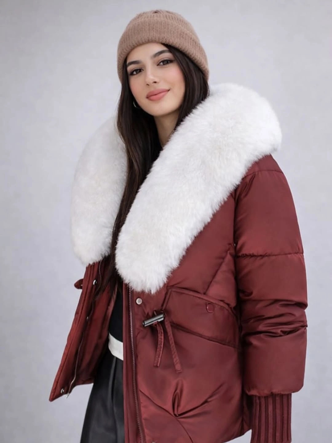 Burgundy long puffer jacket with white plush collar and beige beanie