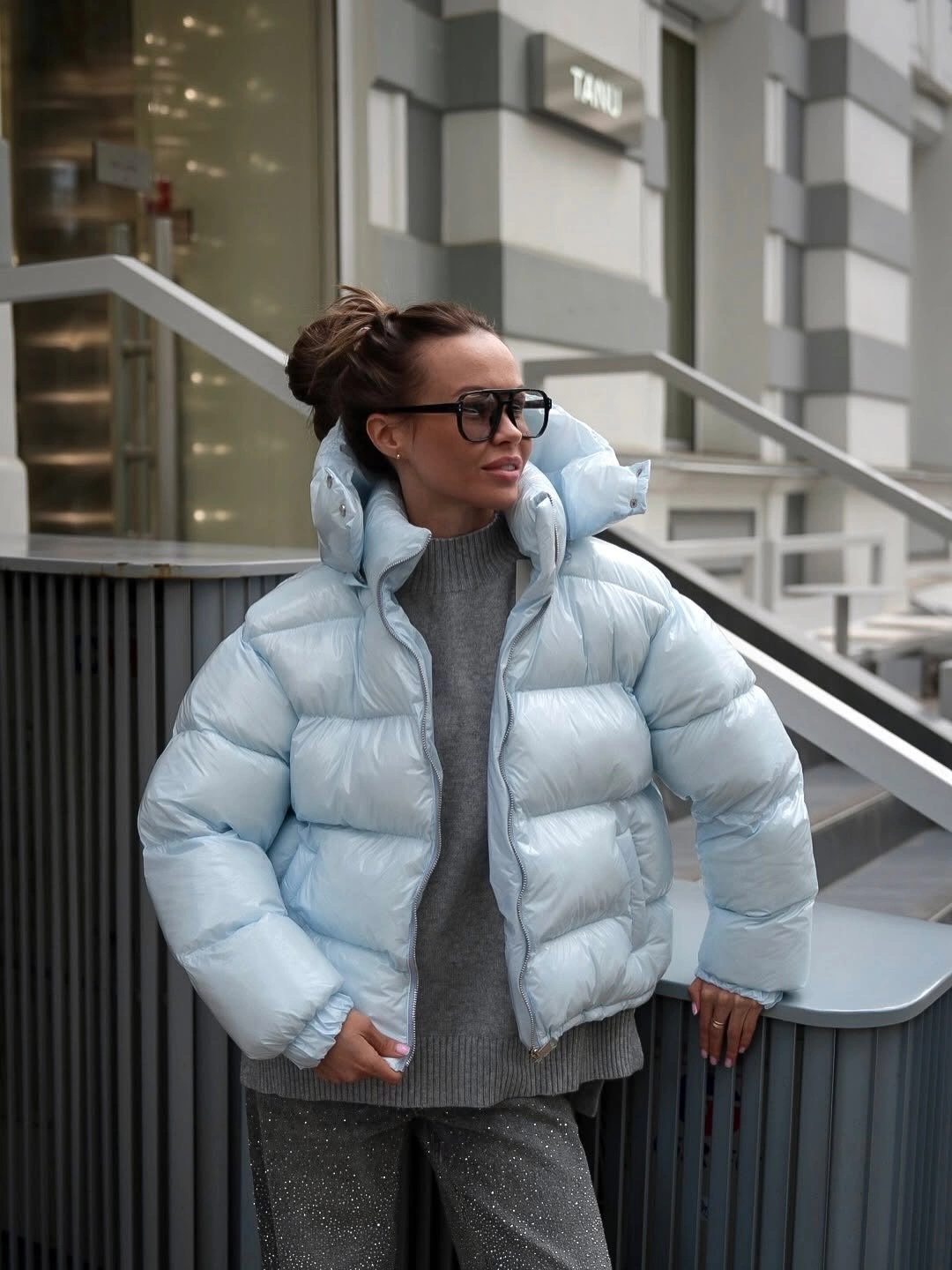 Icy blue puffer jacket with gray sweater and textured gray trousers